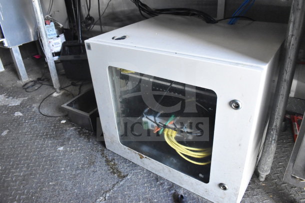 Interior view of 2020 Diamond Cargo 8.5'x24' food trailer, showing the electrical setup and wiring inside a control cabinet.