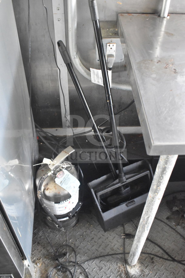 2020 Diamond Cargo 8.5'x24' food trailer interior showing cleaning tools and a fire extinguisher with inspection tag.