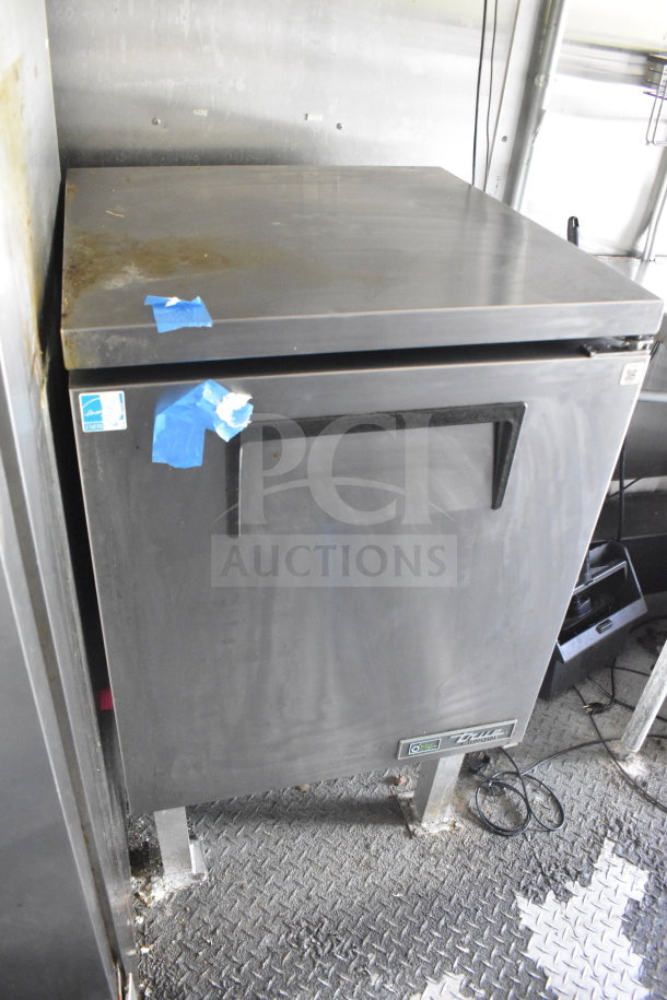 2020 Diamond Cargo 8.5'x24' food trailer interior with stainless steel fridge. Minor surface blemishes, energy-efficient label visible.
