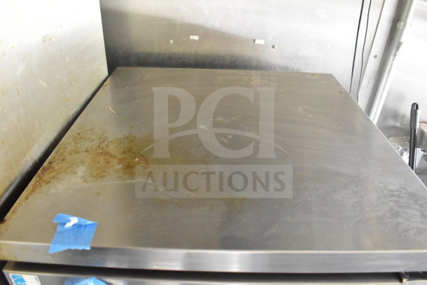 "2020 Diamond Cargo 8.5'x24' food trailer interior with stainless steel counter showing wear and taped blue label."