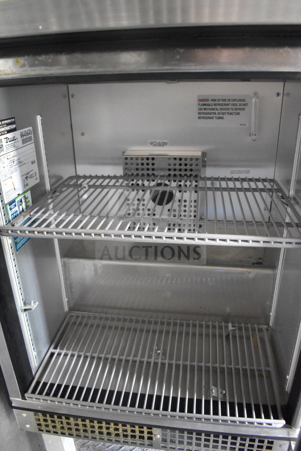 2020 Diamond Cargo 8.5'x24' food trailer interior, showing empty stainless steel shelving in good condition. Labels indicate refrigeration unit details and safety warnings.