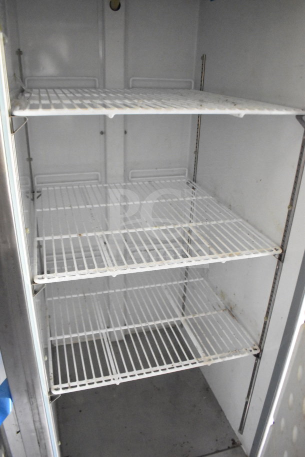 Interior view of wire shelving in a 2020 Diamond Cargo 8.5'x24' food trailer. The shelves show signs of use.