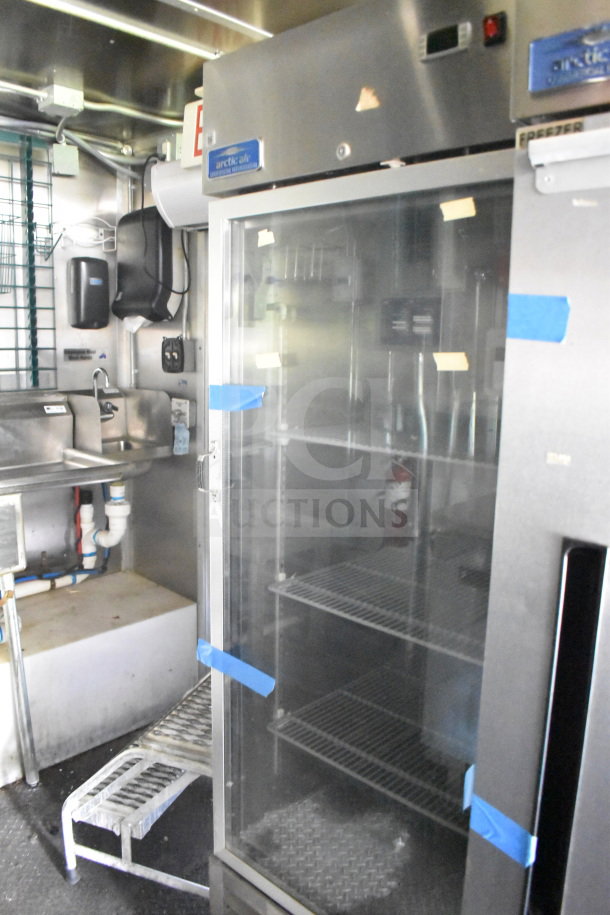 2020 Diamond Cargo 8.5'x24' food trailer interior with stainless steel fixtures and Arctic Air freezer.