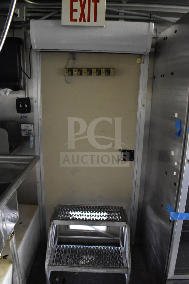 2020 Diamond Cargo 8.5'x24' food trailer interior showing exit sign, step ladder, and stainless steel fixtures.