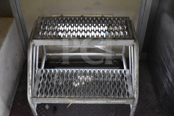 Metal step stool in used condition with a "Cotterman" label, showing visible wear.