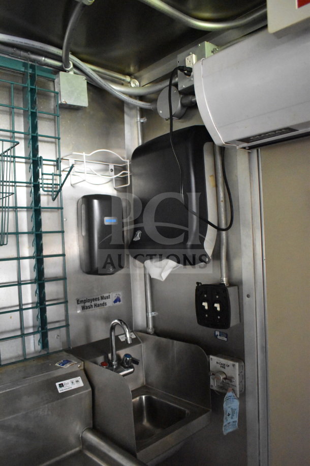 2020 Diamond Cargo 8.5'x24' food trailer interior showing sink, hand sanitizer, and electrical outlets. Clean condition.