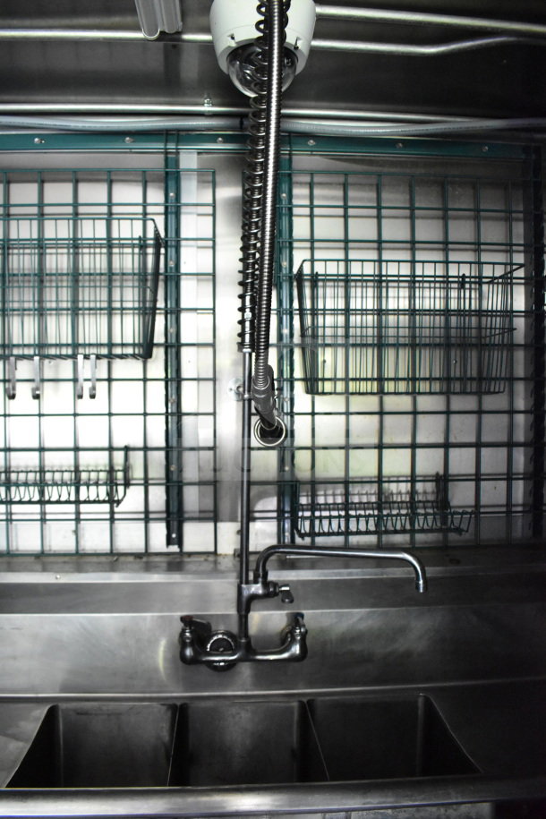 2020 Diamond Cargo 8.5'x24' food trailer interior, featuring a stainless steel triple sink, overhead shelving, and clean condition.