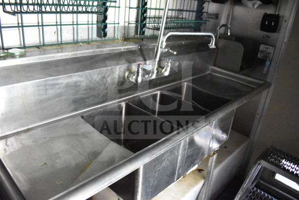 2020 Diamond Cargo 8.5'x24' food trailer interior showing a stainless steel triple sink and shelving.