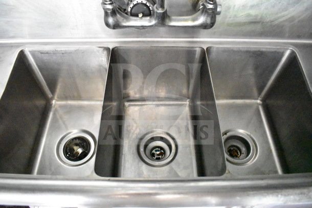 Triple stainless steel sink with integrated drains in a 2020 Diamond Cargo 8.5'x24' food trailer. Clean condition.