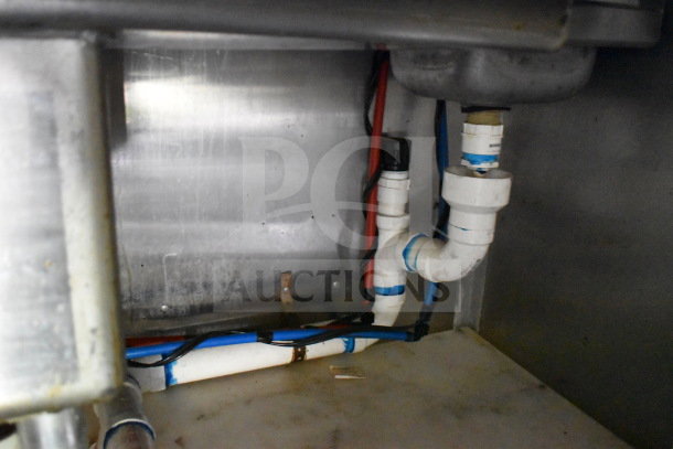 Plumbing system of 2020 Diamond Cargo 8.5'x24' food trailer, showing pipes and connections, in used condition.