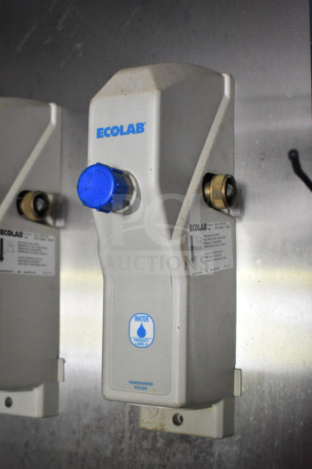 Ecolab water filter unit with a blue knob, mounted on a wall. Labels indicate water flow and filter specifications.