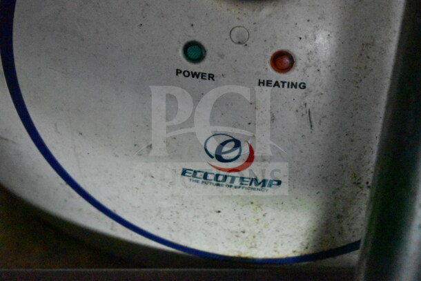 Eccotemp water heater controls, featuring power and heating indicators, slightly dusty, with brand logo visible.