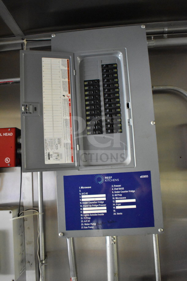 Electrical panel in a 2020 Diamond Cargo 8.5'x24' food trailer, with labeled breaker switches and a blue Reef Kitchens label. VIN: 53NBE2422L1083693.