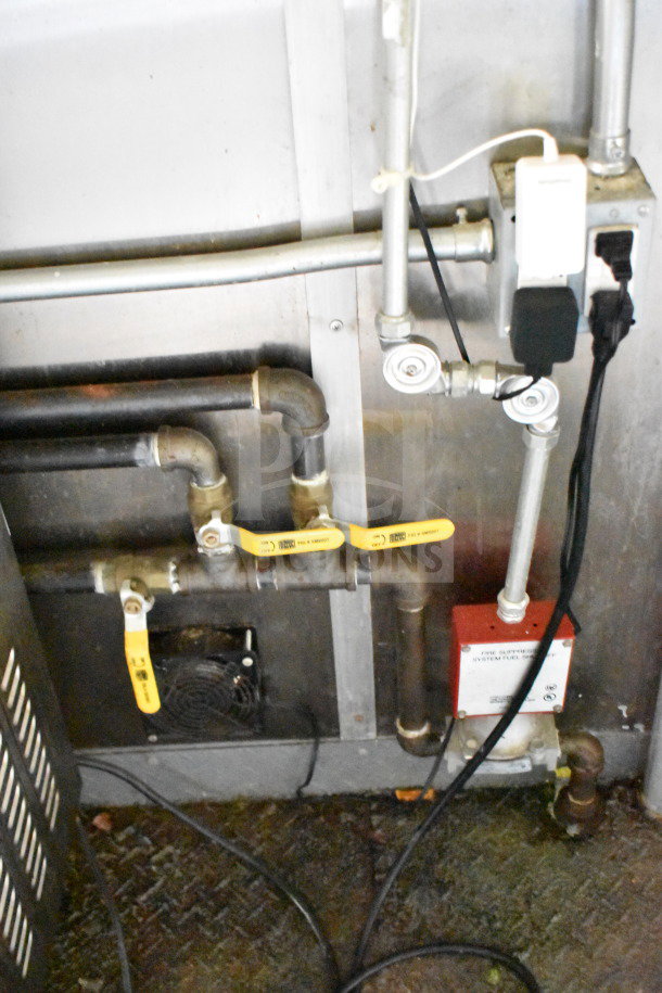 Interior of a 2020 Diamond Cargo 8.5'x24' food trailer showing plumbing and wiring, includes labeled valves and fire safety system components.