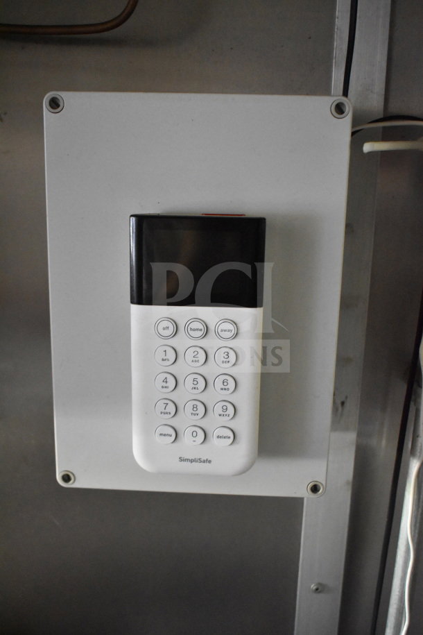 SimpliSafe keypad system inside 2020 Diamond Cargo 8.5'x24' food trailer, enhancing security features.