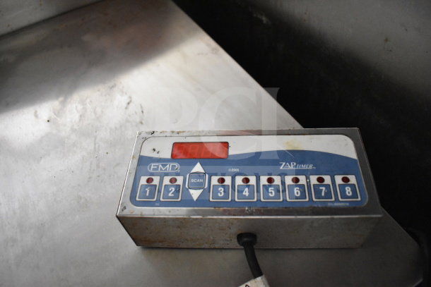Control panel of an FMP timer system on a stainless steel surface in a 2020 Diamond Cargo food trailer.