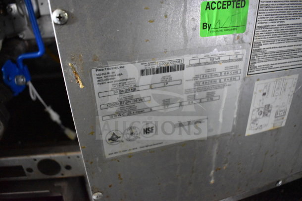 Close-up of Diamond Cargo food trailer's equipment label. Shows specs, model SG14R. Green "Accepted" sticker visible.