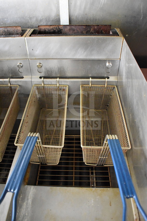 Dual basket deep fryer in the 2020 Diamond Cargo 8.5'x24' food trailer, showing blue handles and stainless steel finish.
