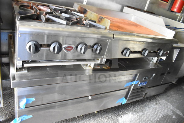 Interior of a 2020 Diamond Cargo 8.5'x24' food trailer. Features a Wells stove and grill setup. Light signs of use.