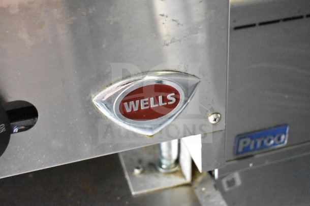 Close-up of "Wells" logo on equipment inside 2020 Diamond Cargo 8.5'x24' food trailer, visible metal finish and detailing.