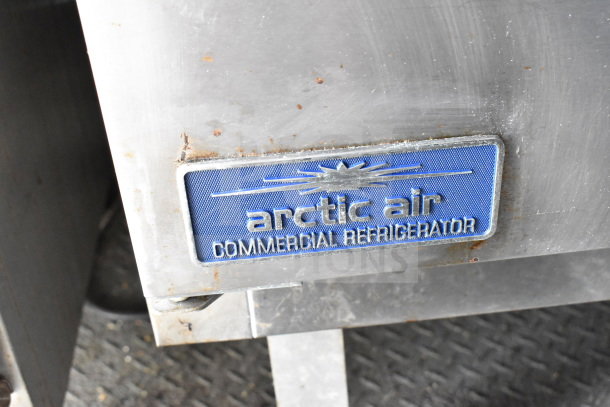 Arctic Air commercial refrigerator label on a metal surface with slight rust. Part of the 2020 Diamond Cargo food trailer equipment.