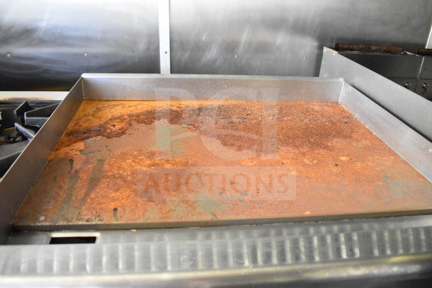 Rusty griddle inside a 2020 Diamond Cargo 8.5'x24' food trailer, showing wear and surface corrosion.