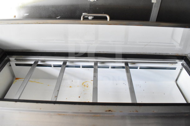 Open storage compartment inside 2020 Diamond Cargo 8.5'x24' food trailer; visible metal dividers, some debris present.