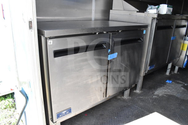 2020 Diamond Cargo 8.5'x24' food trailer interior, features Arctic Air commercial refrigerator, visible wear on door.