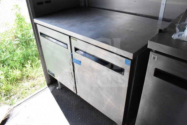 2020 Diamond Cargo 8.5'x24' food trailer interior showing stainless steel countertop and refrigeration unit, minor wear visible.