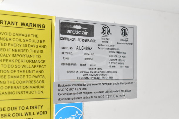 Image showing a label from an Arctic Air commercial refrigerator, model AUC48RZ, with design specifications and warnings.