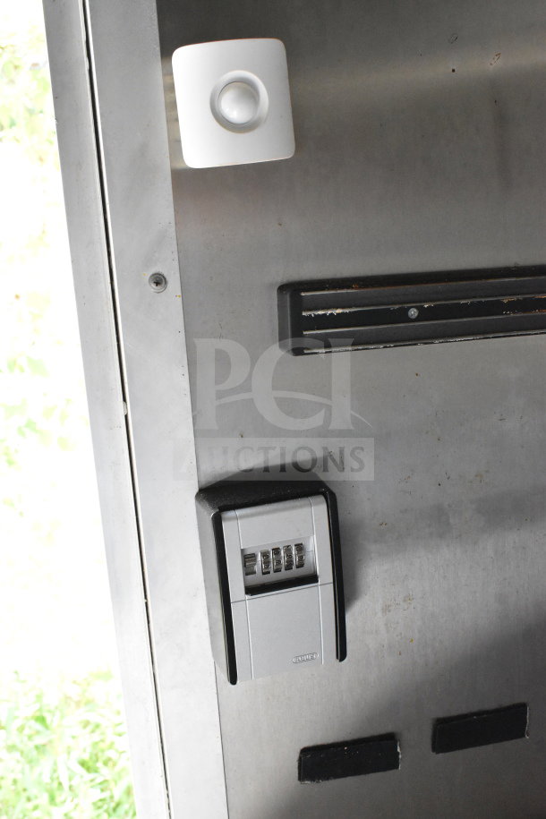 2020 Diamond Cargo 8.5'x24' food trailer interior, features stainless steel surface and combination lock box on door.