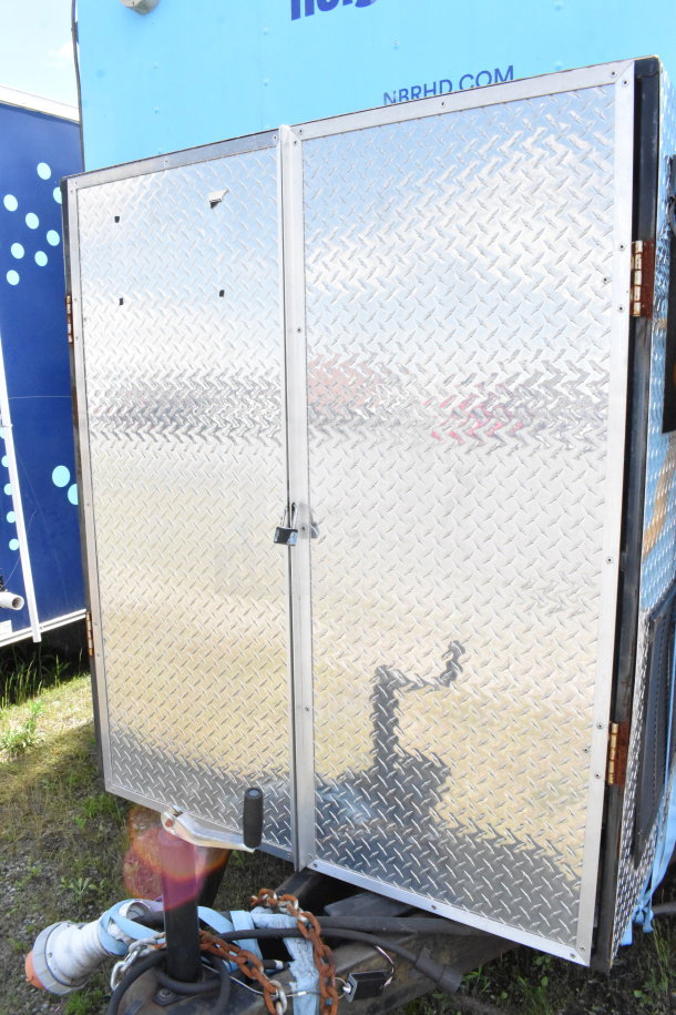 2020 Diamond Cargo 8.5'x24' food trailer with durable aluminum exterior, lockable door, and hitch setup. VIN: 53NBE2422L1083693.