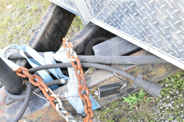 2020 Diamond Cargo 8.5'x24' Food Trailer hitch detail with visible chains and cables, showing moderate rust.