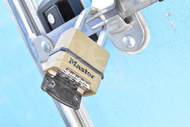 Combination padlock securing a latch on a 2020 Diamond Cargo 8.5'x24' food trailer. Master logo visible.