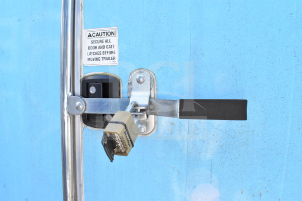 2020 Diamond Cargo food trailer blue exterior, door latch with combination lock, caution label nearby.