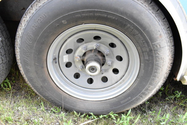 Close-up of a tire and wheel on a 2020 Diamond Cargo 8.5'x24' food trailer, showing tire markings and condition.