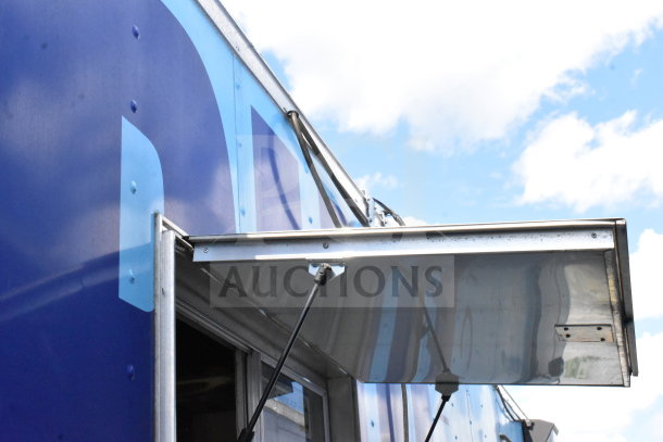 2020 Diamond Cargo 8.5'x24' food trailer with grease hood; blue exterior detailing visible, sturdy condition.