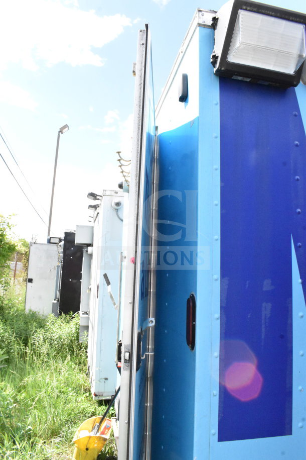 2020 Diamond Cargo 8.5'x24' food trailer, visible side view, blue exterior, with lighting fixtures.
