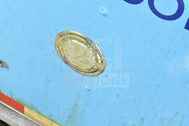 2020 Diamond Cargo 8.5'x24' food trailer detail, featuring blue exterior with visible wear and circular light fixture.