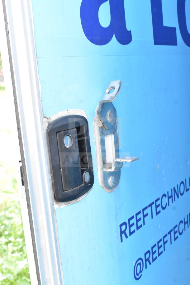 Close-up of a door lock on a 2020 Diamond Cargo food trailer, showing blue exterior with printed text.