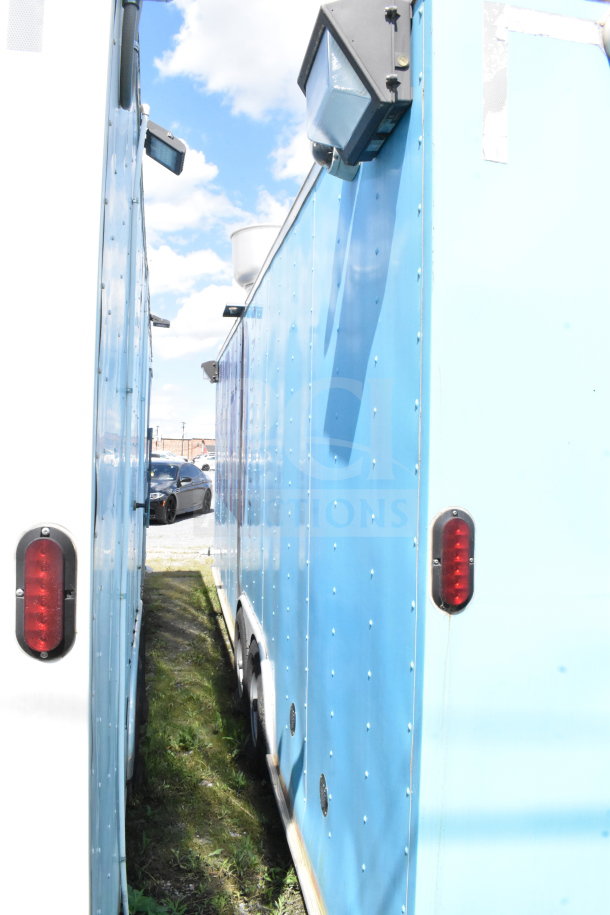2020 Diamond Cargo 8.5'x24' food trailer, blue exterior, with grease hood, suppression system, and refrigeration.