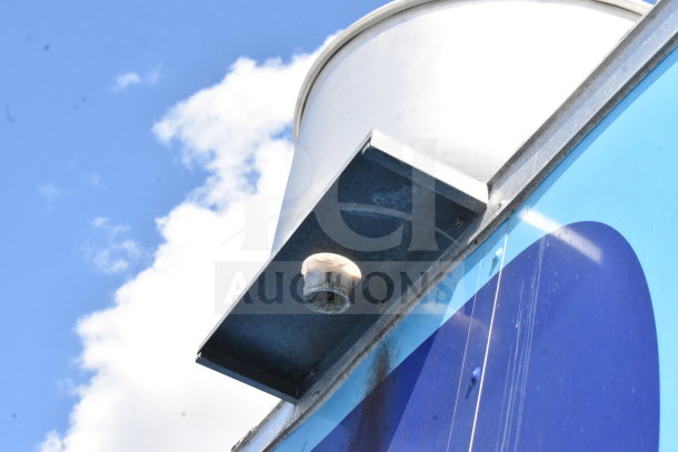 Exterior vent of a 2020 Diamond Cargo food trailer featuring a grease hood, under a clear sky.
