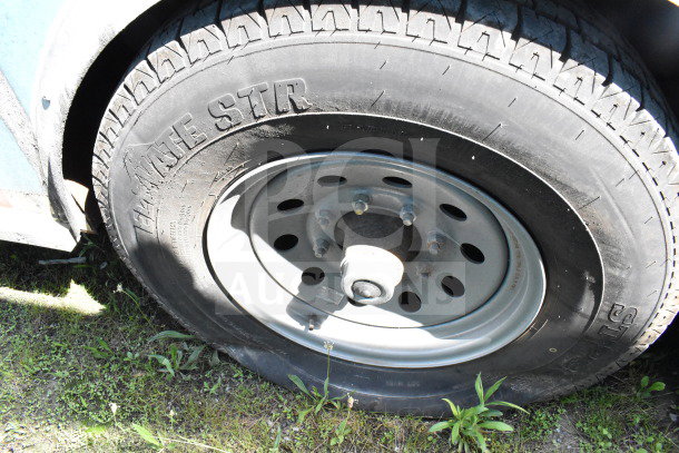 Tire of 2020 Diamond Cargo 8.5'x24' food trailer, featuring trailer wheel with exposed lug nuts and visible tire tread.