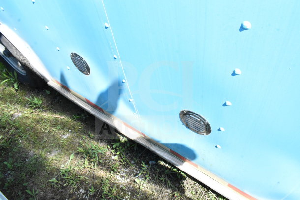 2020 Diamond Cargo 8.5'x24' food trailer, side view, blue exterior, visible vents, wheels partially shown.