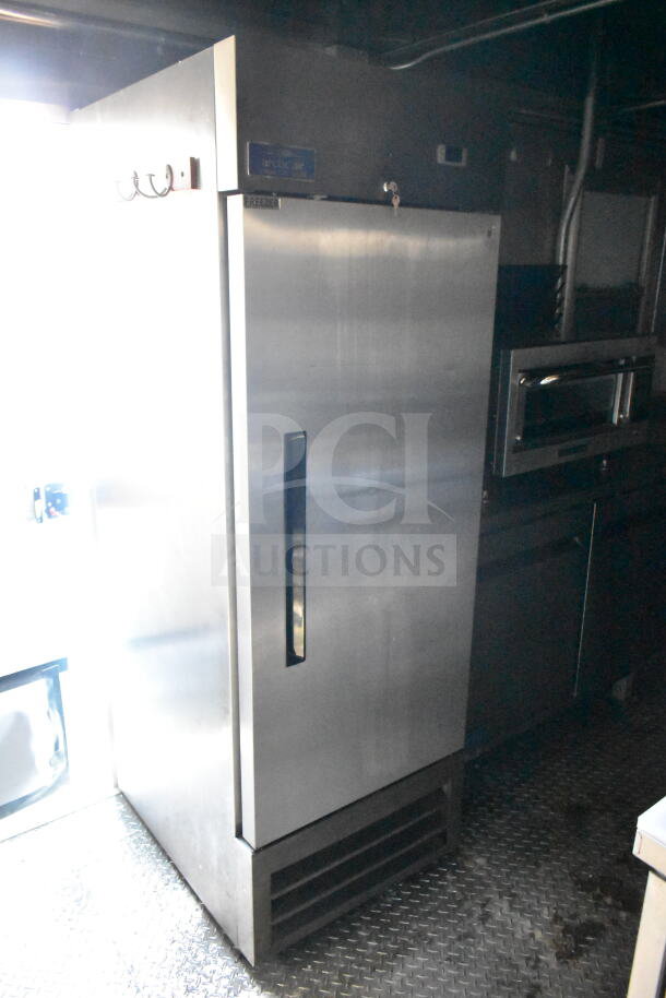 2021 Diamond Cargo 8.5'x24' Food Trailer interior showing Arctic Air refrigerator, featuring grease hood and suppression.