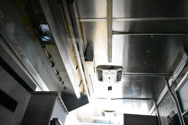 2021 Diamond Cargo food trailer interior showing grease hood and suppression system installation. Clean condition.