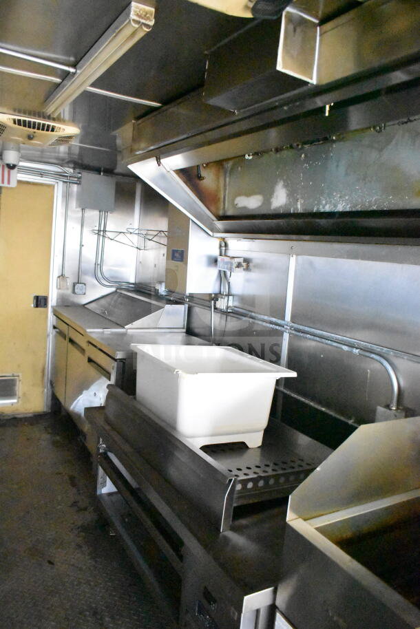 2021 Diamond Cargo 8.5'x24' food trailer interior with grease hood, suppression system, and Frymaster gas fryer, good condition.