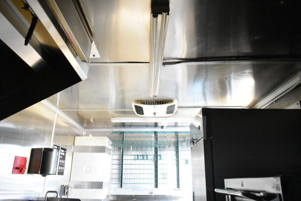 2021 Diamond Cargo 8.5'x24' food trailer interior with grease hood, suppression system, and refrigeration.