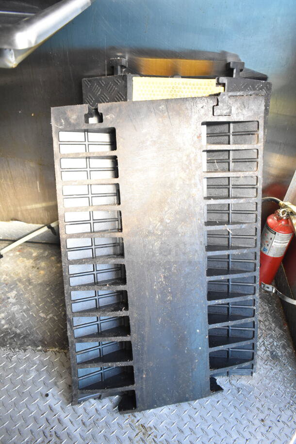 Diamond Cargo 8.5'x24' food trailer interior with black vent panel, metal walls, diamond plate floor, and fire extinguisher.