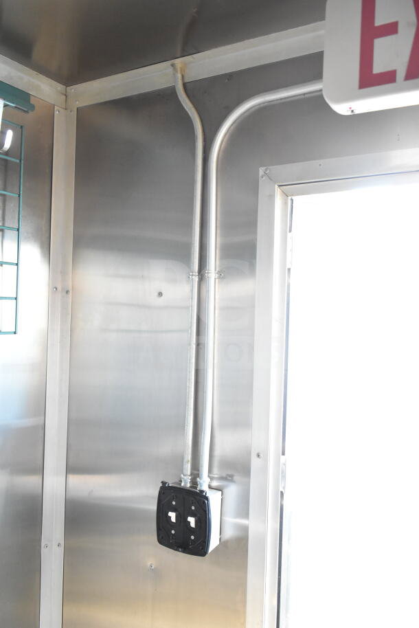 2021 Diamond Cargo 8.5'x24' food trailer interior with grease hood and wiring. Stainless steel finish visible.